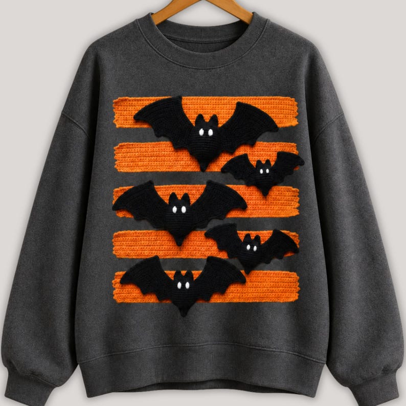 Halloween bat design in PNG format with black bats and orange patterned lines displayed on comfy t-shirt samples in charcoal, brown, olive green, rusty orange and cream for sublimation printing for the horror season and DTF t-shirts.