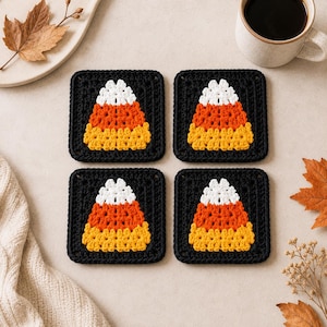 May include: Four square crochet coasters featuring a candy corn design. Each coaster has a black border surrounding a central motif with white, orange, and yellow yarn arranged in a triangular shape to resemble a piece of candy corn.