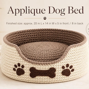 May include: A round, crocheted dog bed featuring a cream-colored exterior with brown paw print and bone appliques. The interior is brown. Text reads: Applique Dog Bed, Finished size: approx. 20 in L x 14 in W x 5 in front / 8 in back, HANDMADE WITH LOVE.