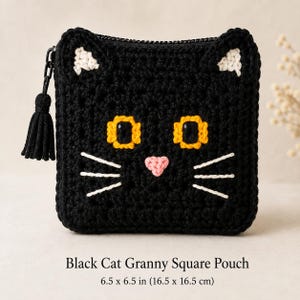 May include: A black crochet pouch shaped like a cat face, featuring white inner ears, yellow eyes with black pupils, a pink nose, and white whiskers. It has a black zipper with a matching black tassel pull and measures 6.5 by 6.5 inches.