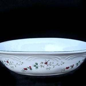 May include: White oval serving bowl with a green rim and a holly and berry design.