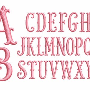 May include: A complete set of uppercase and lowercase letters of the alphabet rendered in a pink embroidered font. The letters feature a decorative, serif-style typeface with prominent curls and loops, showcasing a textured thread-like appearance.