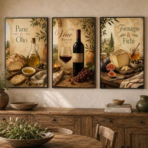 May include: A set of three framed wall art prints featuring rustic culinary scenes. The left print shows bread and olive oil with the text Pane & Olio. The center print displays red wine with the text Vino Rosso. The right print shows cheese and figs with the text Formaggio & Fichi.