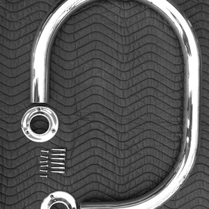 May include: Chrome-plated metal grab bar with two mounting plates and screws. The grab bar is curved and designed for bathroom safety.
