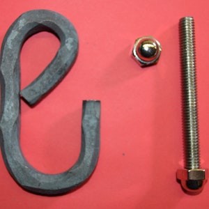 May include: A close-up of a metal hook with a rounded end, a silver bolt with a rounded head, and a silver nut. The hook is made of dark metal and has a rough texture. The bolt and nut are shiny and smooth.
