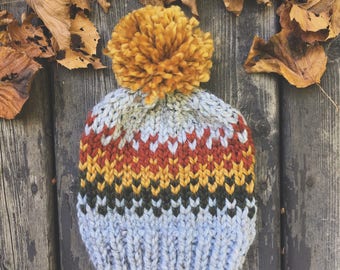 the Sherwoods hat - heathered grey chunky knit hat with rusty orange,  mustard yellow and forest green fair-isle pattern and jumbo pompom -