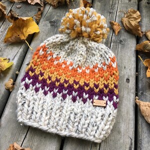 the Sherwoods hat heather oatmeal chunky knit hat with purple, mustard and orange fair-isle pattern and jumbo pompom image 2