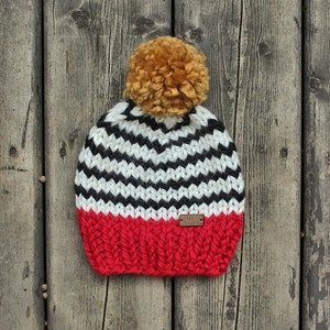 Bright red with black and white stripes chunky knit toddler hat with mustard yellow pompom