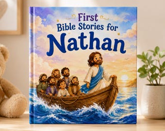 May include: A hardcover book titled First Bible Stories for Nathan featuring a colorful illustration of a figure in a white robe and blue sash standing in a wooden boat with several children on a blue sea under a bright, cloudy sky.