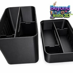 May include: Two black rectangular storage organizers with internal dividers and vertical slots along the inner walls. The logo Beyond imits 3D is visible in the upper right corner, featuring colorful cartoon characters and gears.