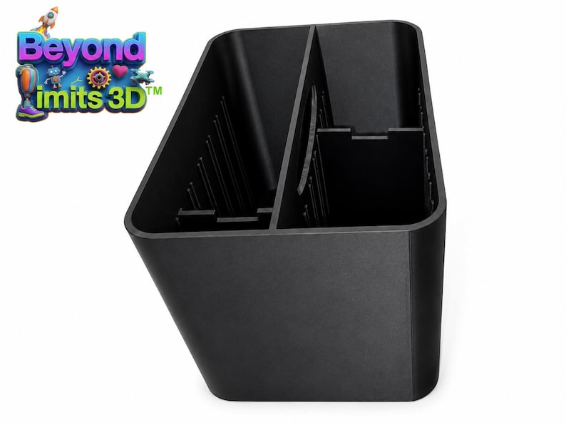 May include: A black plastic storage organizer with a rectangular shape and a central divider. The interior features vertical ribbed slots along the sides for adjustable partitioning. The logo Beyond Limits 3D is visible in the upper left corner.