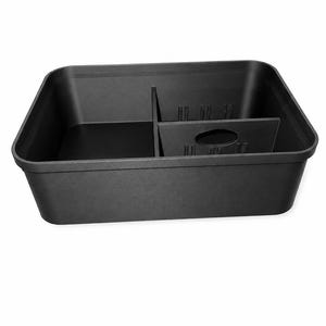 May include: A rectangular black plastic storage bin featuring a single internal divider that separates the interior into two distinct compartments. The divider includes a centered oval cutout and vertical ribbed detailing along its upper edge.