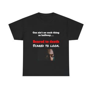 May include: Black t-shirt with the text "Cuz ain't no such thing as halfway... Scared to death, Scared to look." The shirt features a close-up image of a person's eyes.