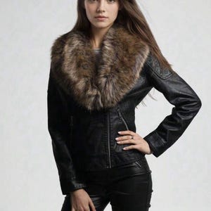 May include: A black jacket featuring a large, thick brown faux fur collar, long sleeves, and a front zipper closure. The jacket has a textured finish on the shoulders and sides, paired with matching black pants with a smooth, dark finish.