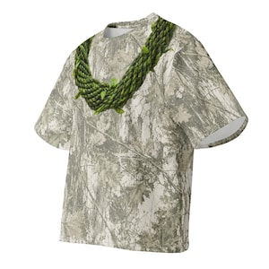 May include: A short-sleeved t-shirt featuring an all-over light grey and white forest camouflage pattern. The shirt displays a prominent graphic print of a thick, braided green lei draped around the neckline, mimicking a natural leaf garland.