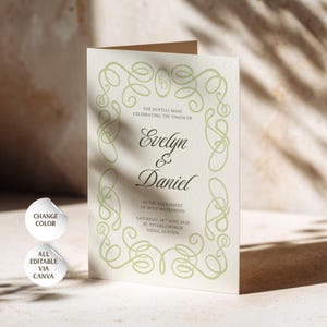 May include: A folded cream-colored wedding invitation card featuring a light green decorative scroll border, the names Evelyn & Daniel, and text detailing a nuptial mass on Saturday, 16th June 2025, at St. Peters Church in Viena, Austria.