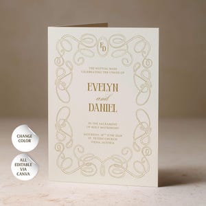 May include: A cream-colored folded wedding program card featuring gold foil-stamped ornate scrollwork borders. The text reads: The Nuptial Mass celebrating the union of Evelyn and Daniel in the sacrament of holy matrimony, Saturday, 16th June 2028, St. Peters Church, Viena, Austria.