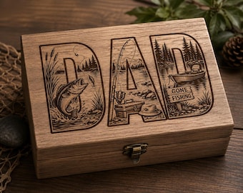 May include: Wooden box with the word "DAD" carved into the lid. The letters are filled with fishing-themed illustrations, including a fish jumping out of the water, a fishing rod, and a boat. The words "GONE FISHING" are also carved into the lid.