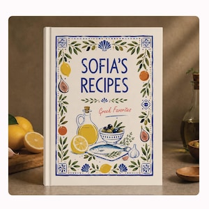 May include: A hardback cookbook titled Sofia's Recipes Greek Favorites with a cream-coloured cover featuring blue, yellow, and green illustrations of lemons, figs, a bottle of olive oil, a bowl of olives, a fish, and garlic cloves.