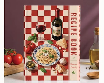 May include: A hardcover recipe book with a red and white checkered cover featuring a plate of spaghetti, a glass of red wine, a wine bottle, tomatoes, olives, garlic, and bread. The text reads RECIPE BOOK BY Romano Family in red lettering.