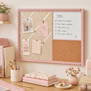 May include: A rectangular wall-mounted organizer board with a pink beaded frame, featuring a beige fabric memo section with crisscross ribbons, a white dry-erase board with a to-do list, and a brown cork board section for pinning notes and photos.