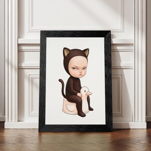 May include: A framed wall art print featuring a cartoon character wearing a brown cat costume with ears and a tail. The character has a serious expression and is sitting on a white duck-shaped potty. The frame is black with a wood grain texture.
