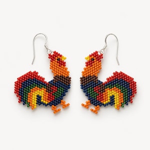 May include: A pair of dangle earrings crafted from small, multi-colored beads arranged to form the shape of a rooster. The design features vibrant red, orange, yellow, green, blue, and brown beads with silver-toned metal hooks for attachment.