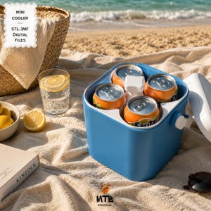 May include: A blue mini cooler holding four orange soda cans, with a white interior and a small tap. The cooler is on a beach towel, with a glass of water with lemon, a bowl of lemons, and a beach bag in the background. The text "MINI COOLER STL-3MF DIGITAL FILES" is in the upper left corner.