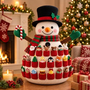 May include: A crochet snowman advent calendar featuring a black top hat with holly, a red and green striped scarf, and green mittens. The snowman body has twenty-four small red pockets, each containing a unique miniature crochet holiday figure.