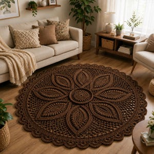 May include: A large, circular, dark brown crochet rug featuring a central medallion surrounded by eight petal-like motifs and an intricate openwork border with a scalloped edge. The rug is crafted with textured yarn, displaying a repeating floral pattern.