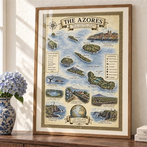 May include: A framed map print titled The Azores, featuring illustrations of the nine islands, surrounding ocean, and various landmarks. The map includes text labels for each island, natural wonders, and experiences, all set against a cream background.