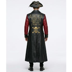 May include: A long black coat with red sleeves and a tricorn hat. The back of the coat features a gold skull and crossbones graphic above the text: IT'S NOT ABOUT WHETHER I CAN OR NOT. I'M GONNA DO IT BECAUSE I WANT TO. The coat has a structured collar.