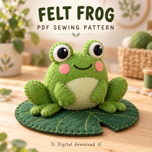May include: A green felt frog plush toy with large black eyes and pink cheeks, sitting on a dark green felt lily pad. The text FELT FROG PDF SEWING PATTERN and Digital download are visible above and below the frog.