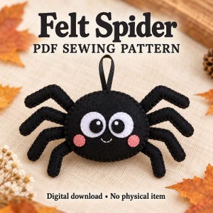 May include: A black felt spider ornament with large white eyes, black pupils, and pink cheeks. The spider has eight legs and a black ribbon loop on top. Text reads: Felt Spider PDF SEWING PATTERN. Digital download • No physical item.