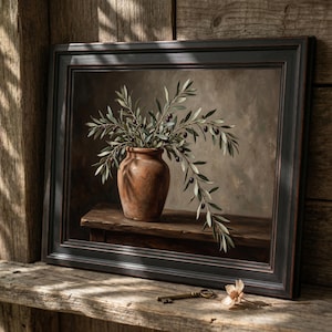 May include: A framed oil painting depicting a terracotta vase filled with olive branches featuring green leaves and small dark olives. The vase sits on a wooden surface against a neutral background, all enclosed in a dark, textured frame.