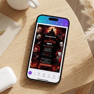 May include: A smartphone displaying a digital Halloween party invitation featuring horror movie characters, a haunted castle, and pumpkins. The text reads Halloween Party, October 31, and Costume Encouraged, set against a dark, red-toned background.