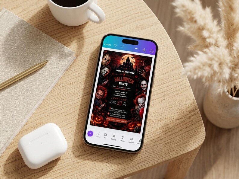 May include: A smartphone displaying a digital Halloween party invitation featuring horror movie characters, a haunted castle, and pumpkins. The text reads Halloween Party, October 31, and Costume Encouraged, set against a dark, red-toned background.