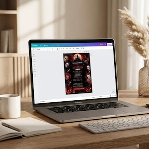 May include: A silver laptop displaying a digital Halloween party invitation template on a screen. The invitation features dark imagery of horror characters, a haunted castle, and red text. The laptop sits on a wooden desk with a white mug and notebook.
