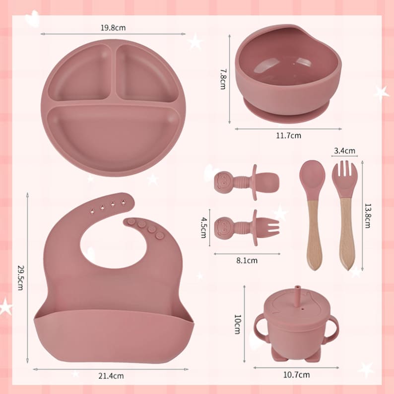 May include: A set of baby feeding essentials in a dusty rose color. Includes a divided plate (19.8 cm), a suction bowl (11.7 cm), a bib (21.4 cm), a sippy cup (10.7 cm), two teethers (8.1 cm), and a spoon and fork (13.8 cm).