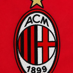 May include: An embroidered AC Milan football club logo patch on a solid red fabric background. The oval emblem features black and red vertical stripes on the left, a red cross on a white background on the right, the text ACM, 1899, and a gold star.