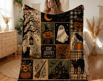 May include: A rectangular throw blanket featuring a patchwork design with Halloween motifs including a ghost, jack-o'-lanterns, black cats, a haunted house, a broom, and sunflowers. The center panel displays the text Stay Spooky in a decorative font.