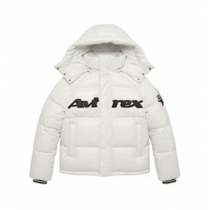 May include: A white puffer jacket with a hood. The jacket features the black text "Avi rex" across the chest. The jacket has a black and white striped cuff and a small patch on the right sleeve.
