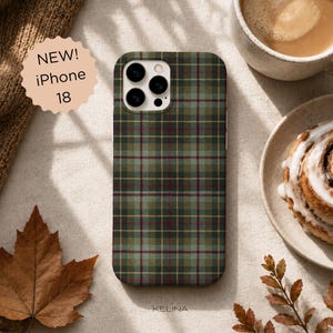 May include: A rectangular phone case for an iPhone 18 featuring a dark green, light green, and maroon plaid tartan pattern with thin yellow grid lines. The case has a white camera cutout area with three circular lens openings and a flash port.
