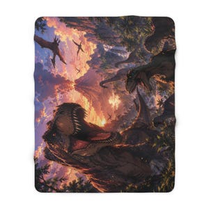 May include: A plush blanket featuring a detailed illustration of dinosaurs in a prehistoric landscape. The artwork depicts a Tyrannosaurus Rex with an open mouth, other dinosaurs, and flying reptiles against a sunset sky. The color palette includes shades of orange, brown, and green.