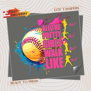 May include: A DTF transfer sheet featuring a yellow softball with pink stitching, surrounded by blue and pink paint splatters. The text reads ALL THE PRETTY GIRLS WALK LIKE this! next to four yellow silhouettes of softball players in various poses.