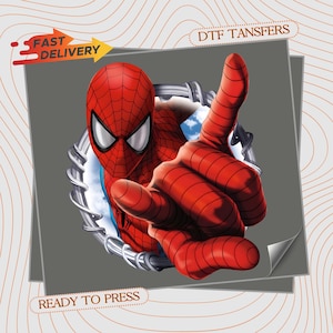 May include: A DTF transfer sheet featuring a graphic of a red and blue costumed superhero reaching forward through a circular metallic portal. The design includes the text FAST DELIVERY, DTF TANSFERS, and READY TO PRESS on a gray background.
