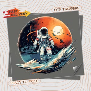 May include: A DTF transfer sheet featuring a graphic of an astronaut in a white suit floating above a stylized blue and orange planet surface. The design includes the text FAST DELIVERY and DTF TANSFERS and READY TO PRESS on a gray background.