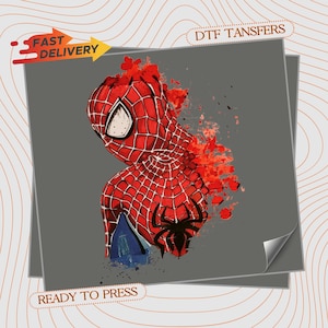May include: A DTF transfer sheet featuring a graphic of a red and black spider-themed character with a web pattern, accented by red paint splatter effects. The design includes the text "FAST DELIVERY" and "READY TO PRESS" on a gray background.