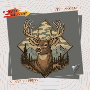 May include: A brown deer illustration with large antlers, set against a backdrop of mountains, trees, and a camouflage pattern. The design is framed within a diamond shape. Text includes "FAST DELIVERY" and "READY TO PRESS".