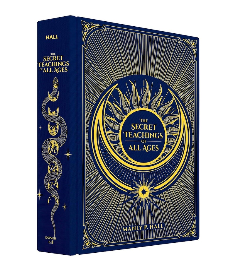 May include: A hardcover book titled "The Secret Teachings of All Ages" by Manly P. Hall. The book has a dark blue cover with gold-colored illustrations, including a sunburst design and a serpent. The spine features a serpent illustration and the word "HALL".